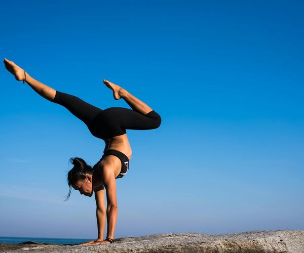 A person demonstrating strength and flexibility in a yoga pose.